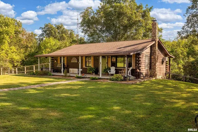 a view of a house with a swimming pool and porch with furniture