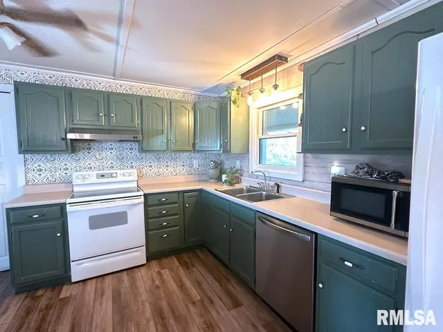 a kitchen with a sink stove and cabinets