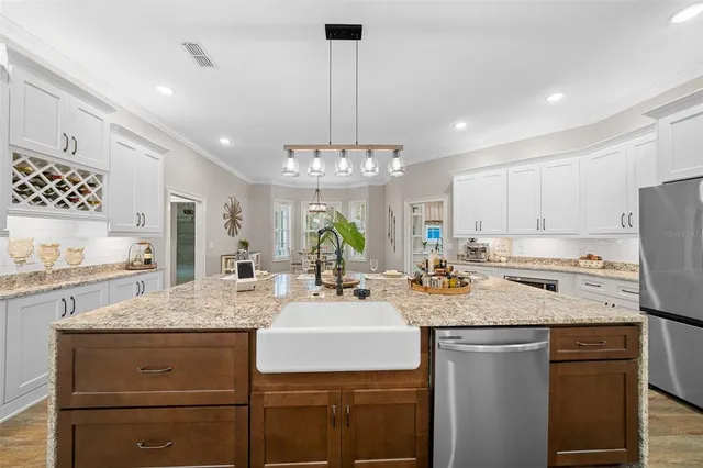 a bathroom with a granite countertop sink a mirror and shower