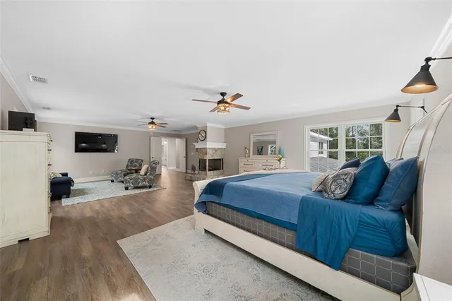 a bedroom with a bed a flat screen tv and a couch