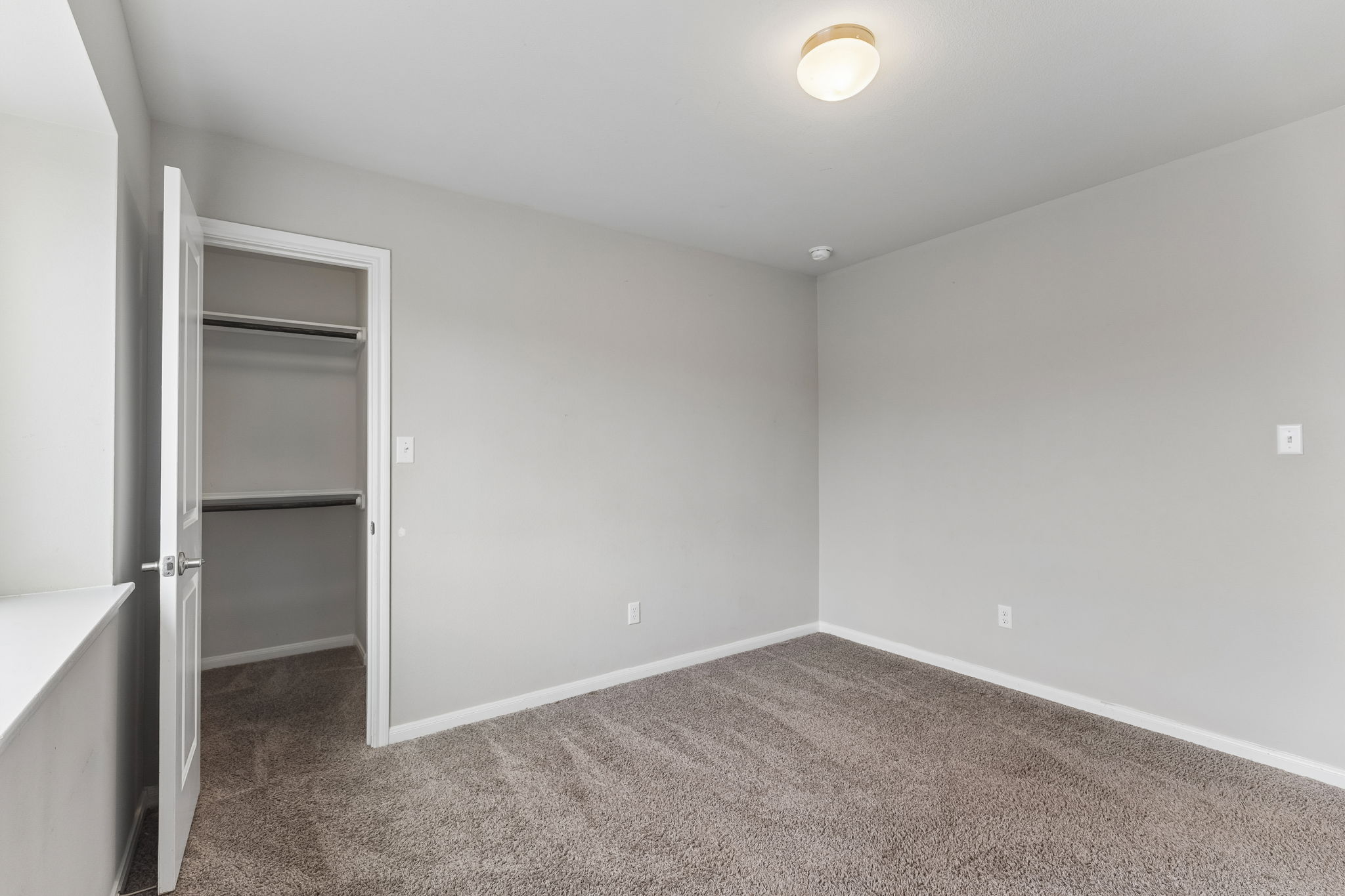 301 Rimrock Court Bastrop, TX 78602 - Photo 16 of 21 A well-proportioned bedroom with a plush carpeted floor and an accessible closet.