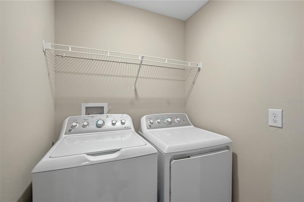 14316 Easy Goer Street Sun City Center, FL 33573 - Photo 8 of 26 a utility room with dryer and washer
