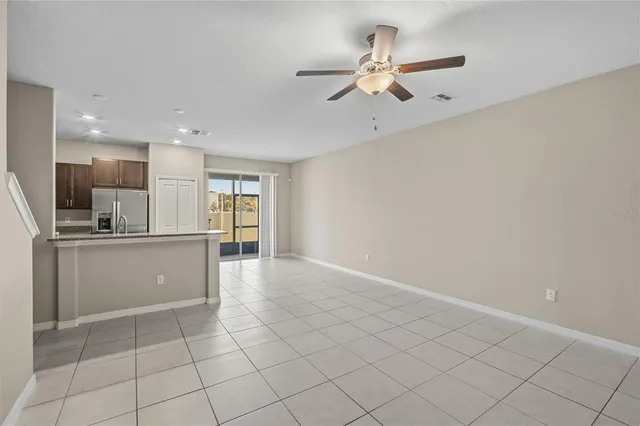 a view of kitchen with windows and ceiling fan