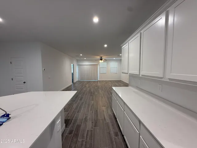 a kitchen with a sink and wooden floor