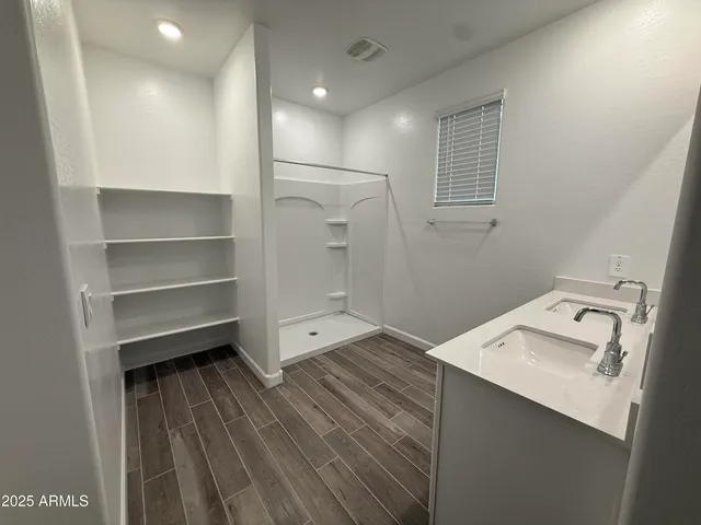 a room with a wooden floor and white walls