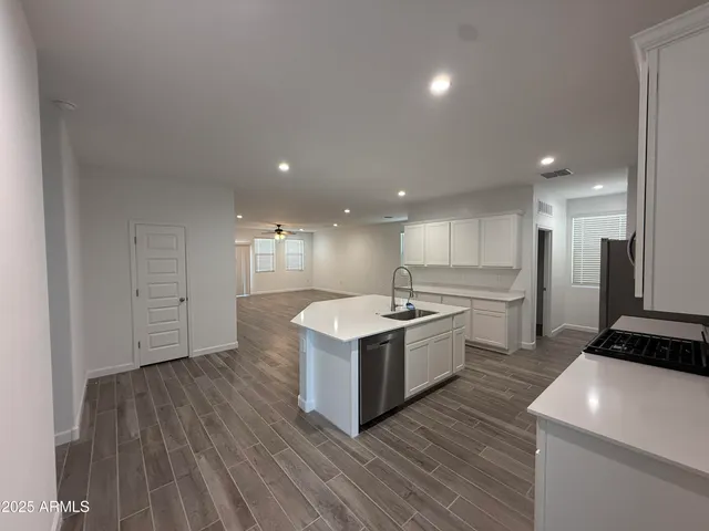 a kitchen with a sink and a stove top oven