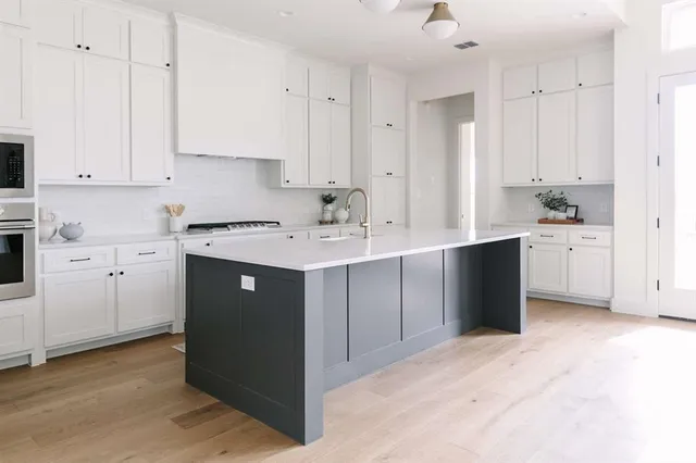 a kitchen with stainless steel appliances granite countertop a sink a stove and a refrigerator