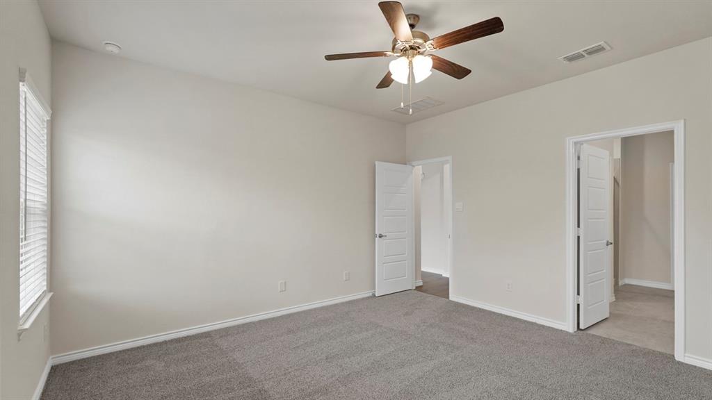 447 Epiphany Lane Lavon, TX 75166 - Photo 18 of 31 Spacious room featuring gray carpet flooring, light neutral-toned walls, and a ceiling fan with integrated lighting