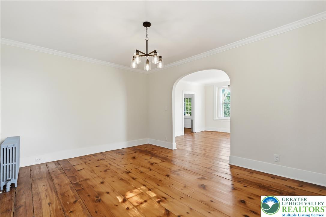 4682 Steuben Road Bethlehem, PA 18020 - Photo 13 of 79 Natural wood flooring complements this generously proportioned room, offering versatile living space.