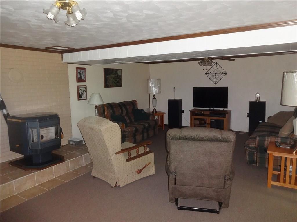 130 Spring Street Yukon, PA 15698 - Photo 8 of 12 Game room with Pellet Stove