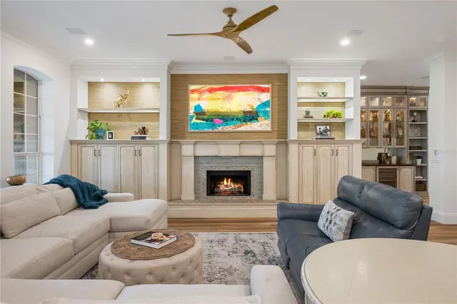 a living room with furniture a flat screen tv and a fireplace