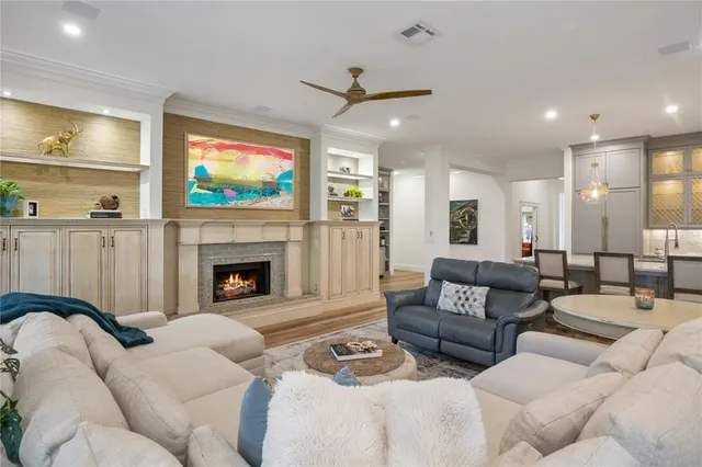 a living room with furniture a flat screen tv and a fireplace