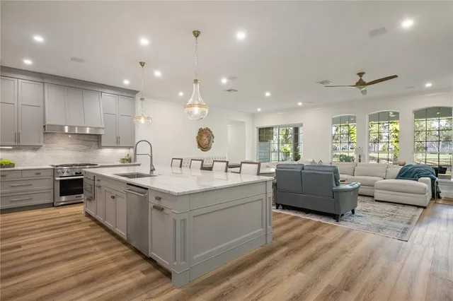 a large kitchen with stainless steel appliances lots of counter top space