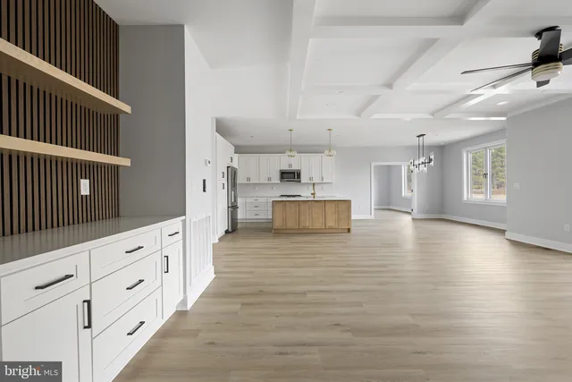 a view of kitchen with stainless steel appliances granite countertop a stove and a refrigerator