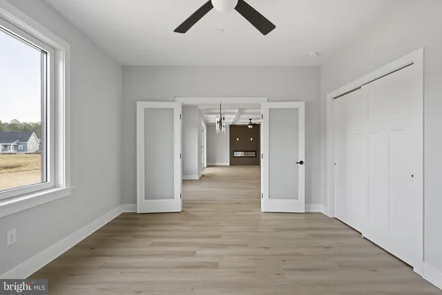 a bathroom with a granite countertop sink vanity mirror and toilet