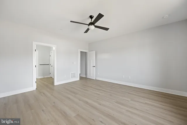 a view of a lake with boats and trees in the background