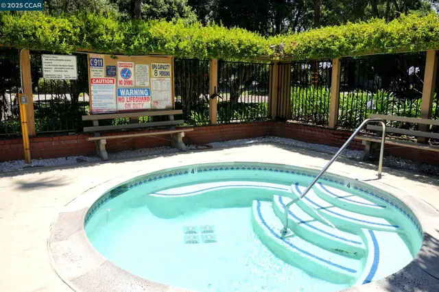 a swimming pool with outdoor seating and yard