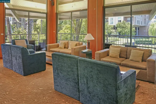 a living room with furniture and a floor to ceiling window