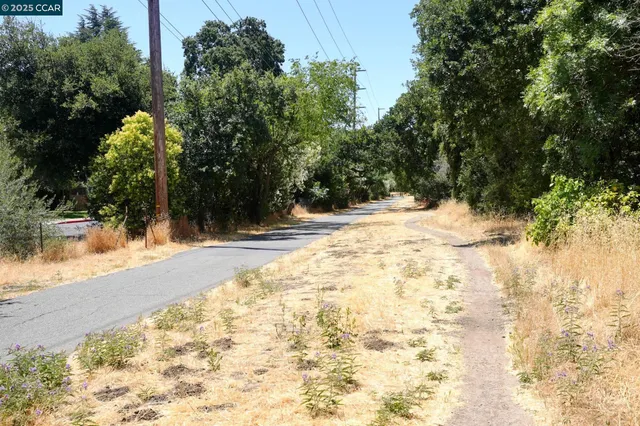 a multi story building with trees in front of it