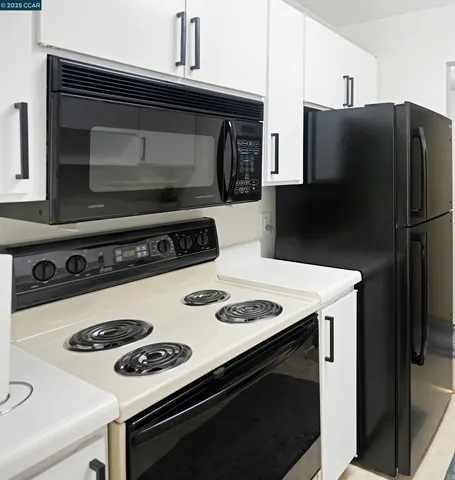 a kitchen with a stove and a refrigerator