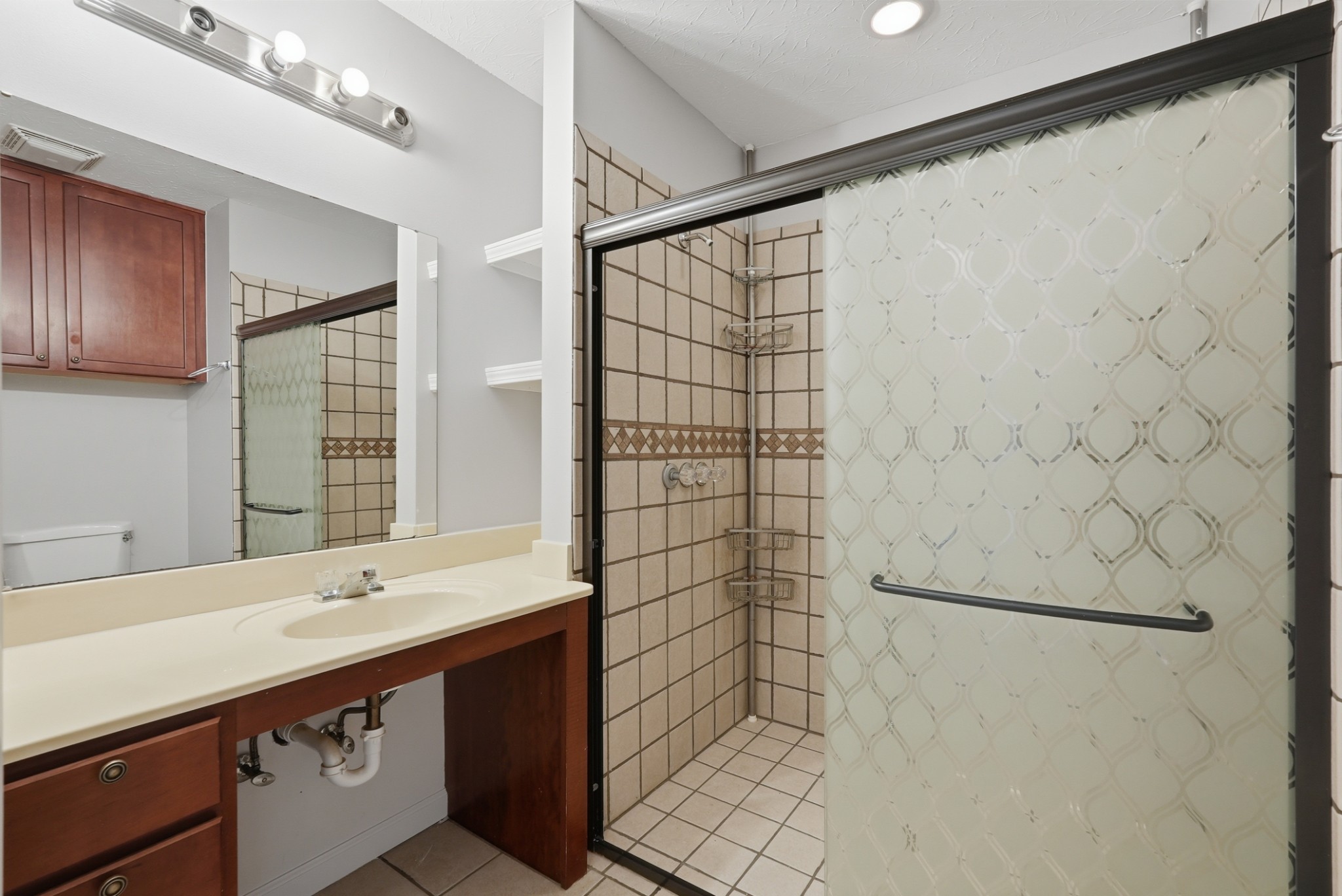 4877 Swafford Road Cookeville, TN 38501 - Photo 10 of 28 a bathroom with a double vanity sink and a shower