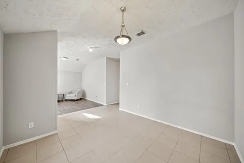 a view of a room with wooden floor and white walls