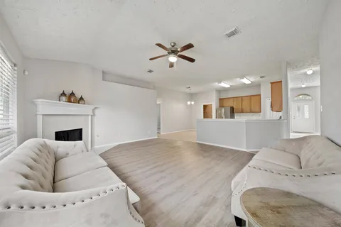 a living room with furniture and a fireplace