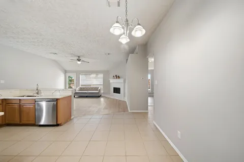 a view of a kitchen with a sink and stainless steel appliances