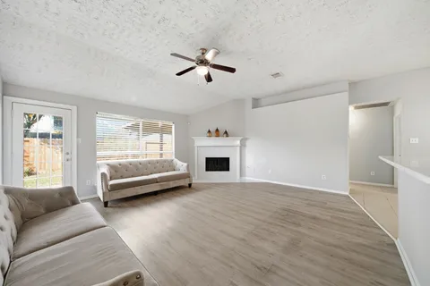 a view of livingroom with furniture wooden floor and windows