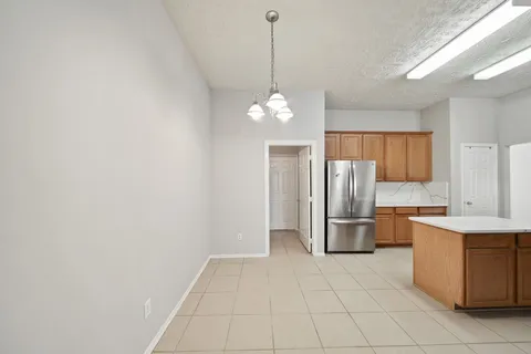 a kitchen with stainless steel appliances a refrigerator and microwave