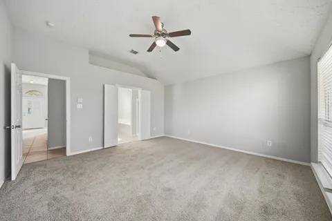 an empty room with closet and windows