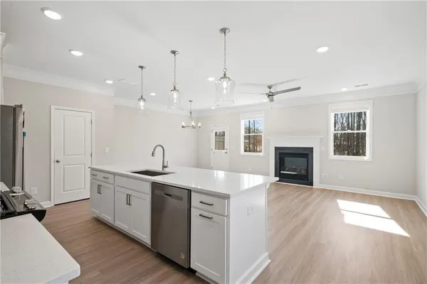 a open kitchen with kitchen island a sink stainless steel appliances and cabinets