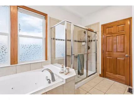 a bathroom with a bathtub and a shower