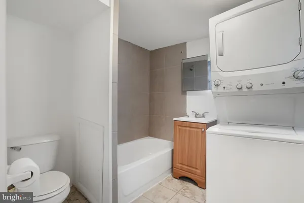 a bathroom with a sink a toilet and bathtub