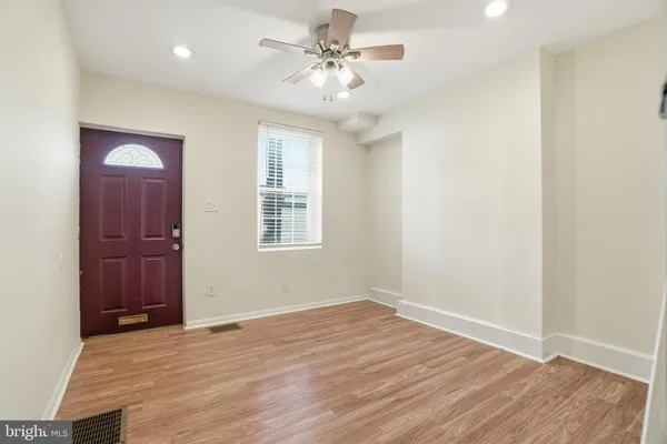 wooden floor in an empty room with a window
