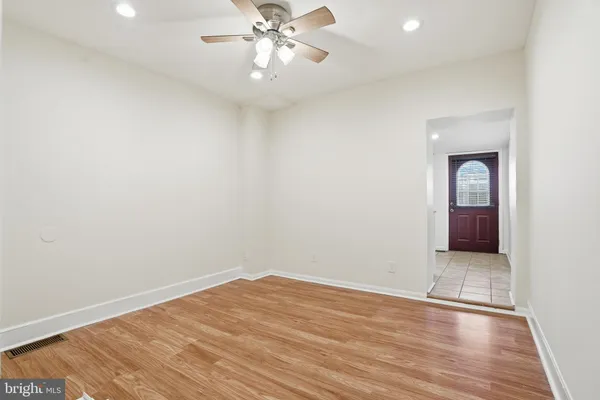 wooden floor in an empty room with a window