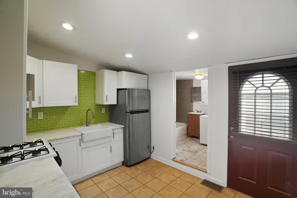 a kitchen with a refrigerator and a sink