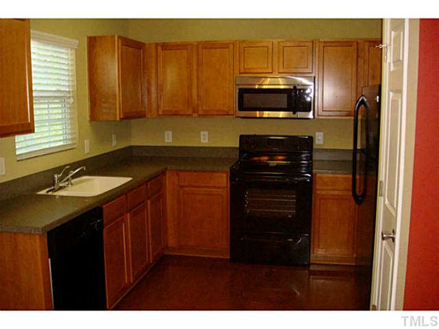 3714 Burtons Barn Street Raleigh, NC 27610 - Photo 3 of 6 Hardwood floors in Kitchen, refrigerator stays