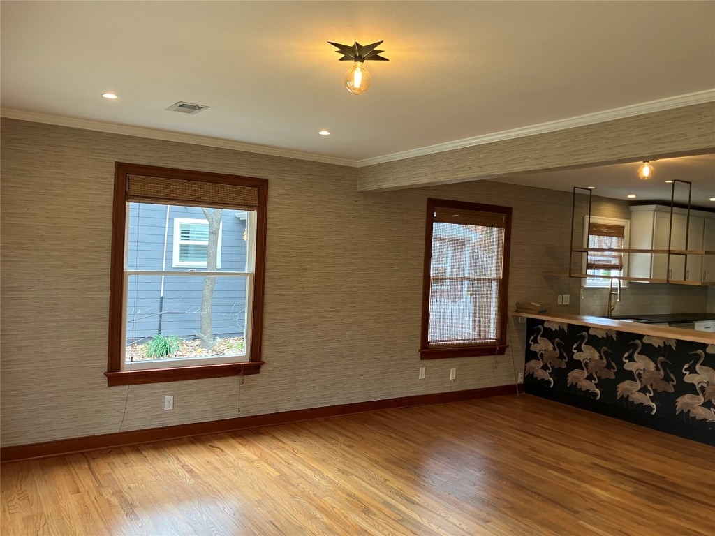 1916 West 39th Street Austin, TX 78731 - Photo 2 of 40 a view of an empty room with a window and wooden floor