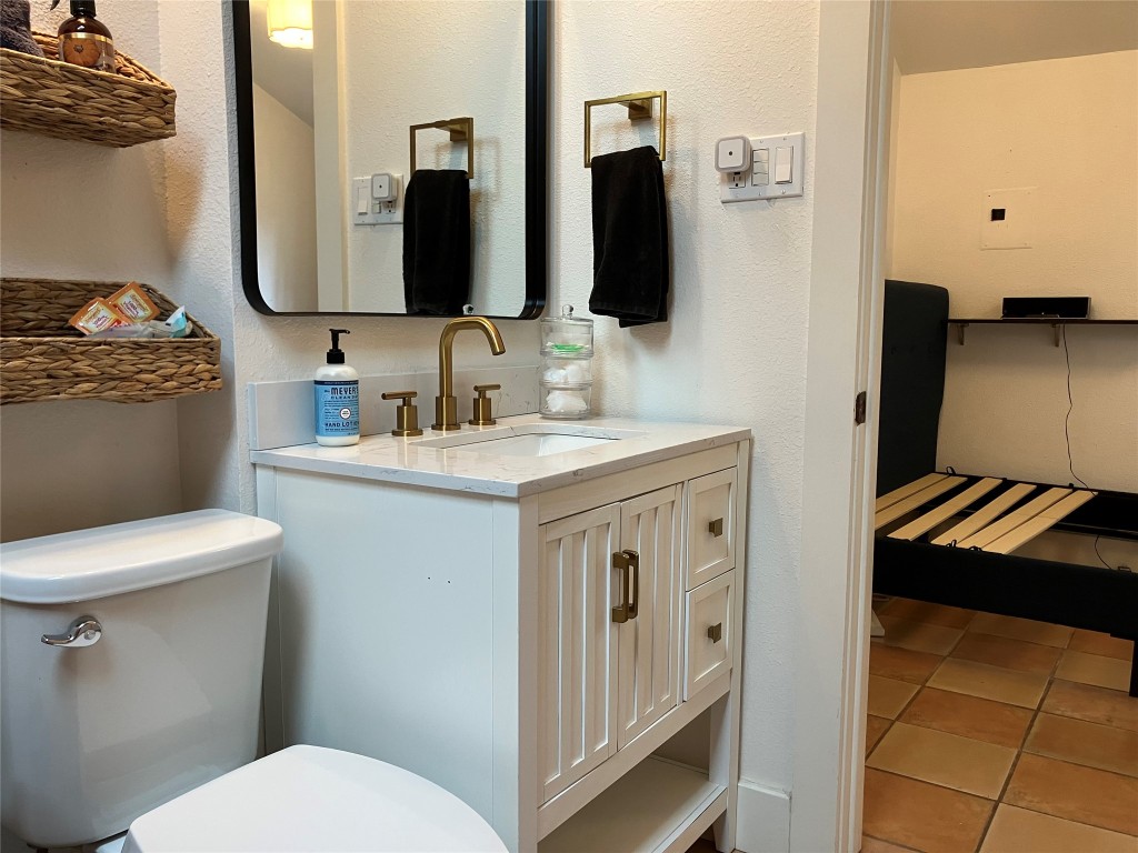 1916 West 39th Street Austin, TX 78731 - Photo 31 of 40 a bathroom with a toilet sink and mirror