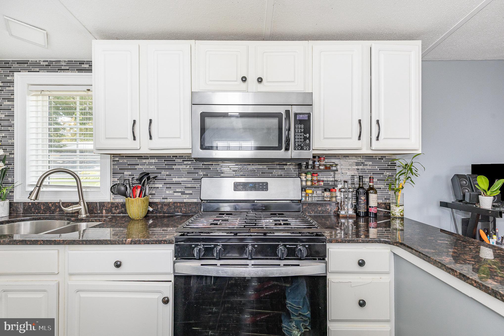 29 Renee Road Stafford, VA 22556 - Photo 11 of 24 a kitchen with granite countertop white cabinets and appliances