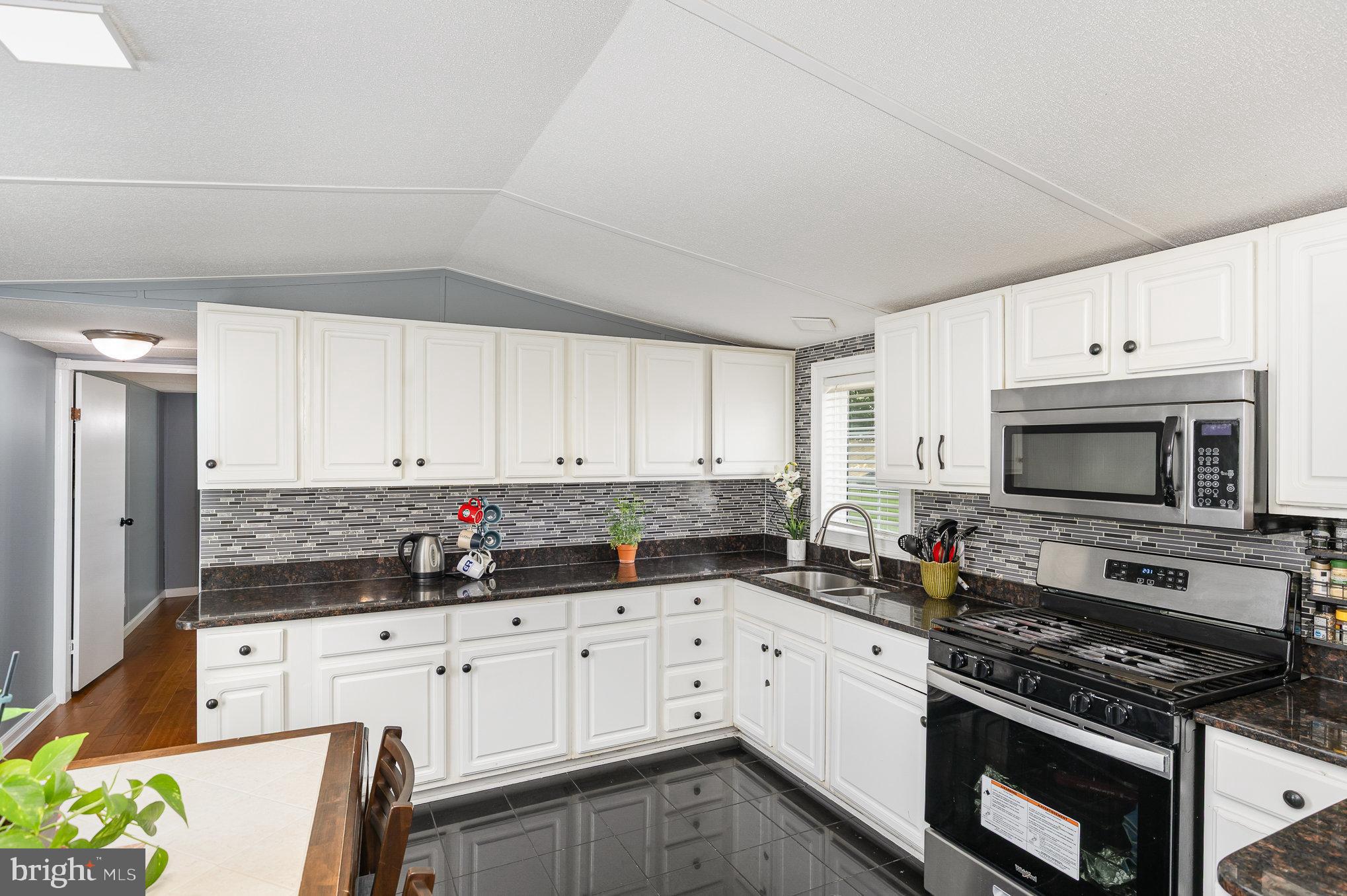 29 Renee Road Stafford, VA 22556 - Photo 13 of 24 a kitchen with granite countertop white cabinets and stainless steel appliances