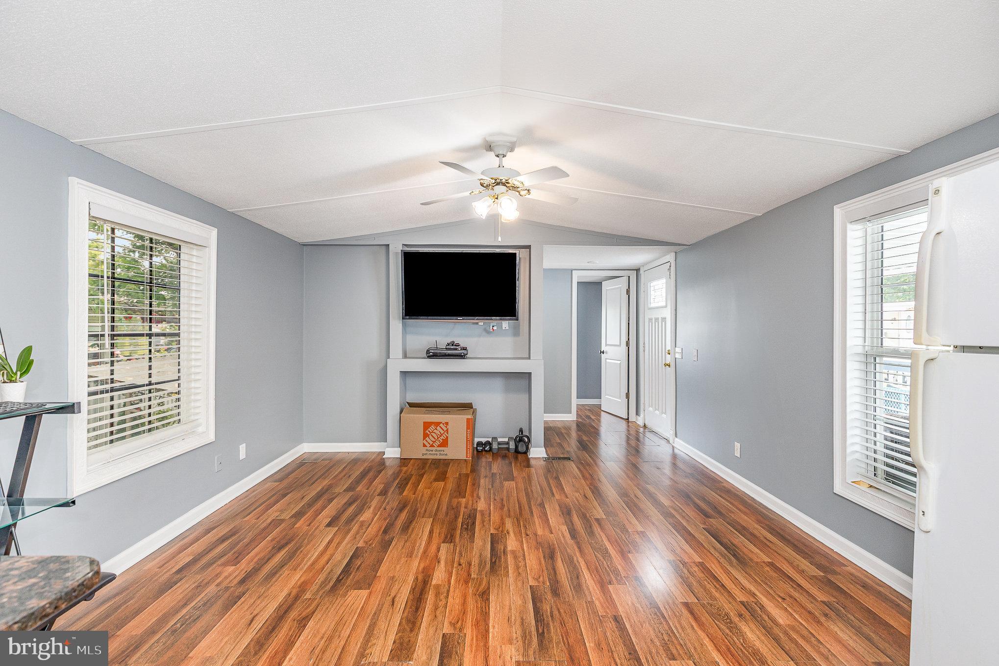 29 Renee Road Stafford, VA 22556 - Photo 7 of 24 a view of a livingroom with a fireplace a ceiling fan and wooden floor