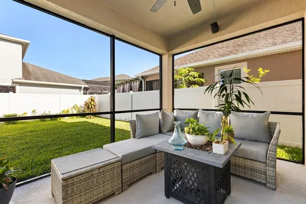 a view of a patio with furniture and a garden