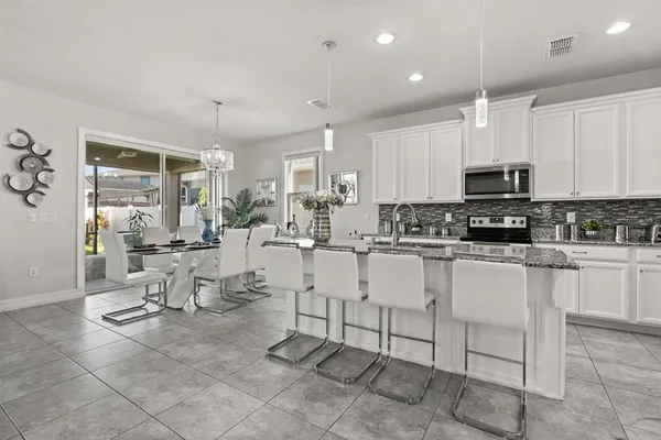 a view of kitchen with sink stainless steel appliances and cabinets