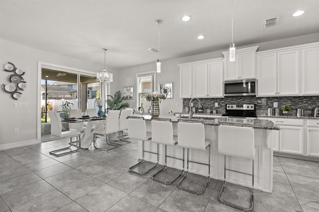 2417 Chateau Loop Kissimmee, FL 34741 - Photo 4 of 16 a view of kitchen with sink stainless steel appliances and cabinets