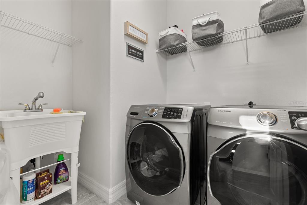 2417 Chateau Loop Kissimmee, FL 34741 - Photo 8 of 16 a utility room with dryer and washer