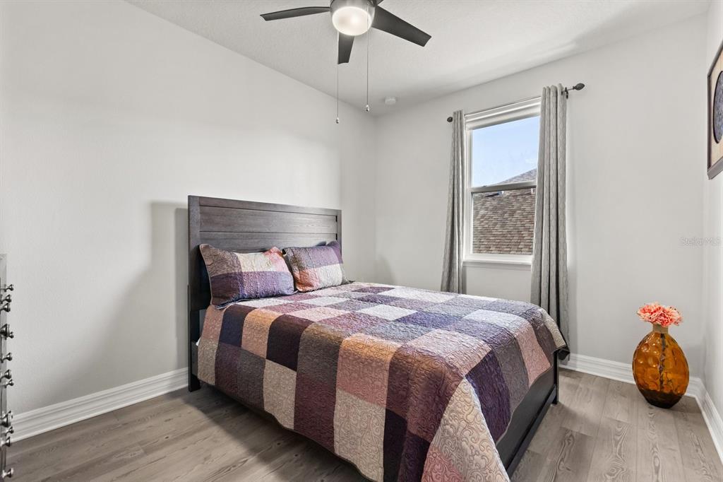 2417 Chateau Loop Kissimmee, FL 34741 - Photo 10 of 16 a bedroom with a bed and a window