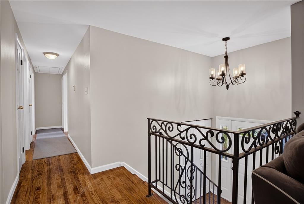 272 Hays Road Pittsburgh, PA 15241 - Photo 15 of 43 Upper hallway landing view showing decorative lighting and polished railing overlooking trhe front entry to the home.