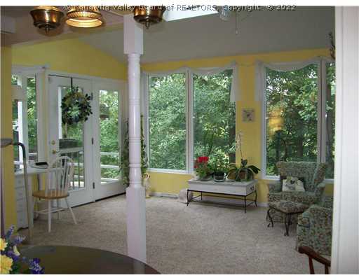 1603 Greystone Road Charleston, WV 25314 - Photo 7 of 16 Interior Space/Layout. Sunroom with Skylights. Open to the Sitting Area and Kitchen. Doors lead to the Covered Deck on the Right and to the Patio area to the left
